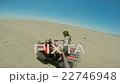 driving the ATV in the desert.  22746948