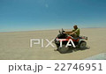 driving the ATV in the desert.  22746951