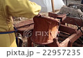 Blacksmith blows the bellows 22957235