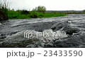 Water stream in a river on cloudy day - closeup. 23433590