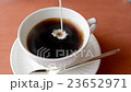 Pouring milk into hot black tea in white cup 23652971