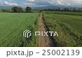 A woman riding a bike on rural road. 25002139