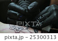 a Professional Tattoo Artist Making Tattoo on the 25300313