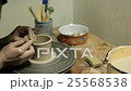 Potter Creates the Product on a Potter's Wheel 25568538
