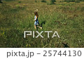 Beautiful Young Girl Smiling and Walking in Field 25744130