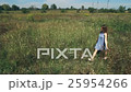 Beautiful Young Girl Smiling and Walking in Field 25954266