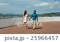 Happy couple walking in hand outdoors  25966457