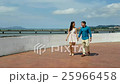 Couple walking on beach 25966458