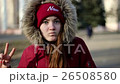 Cheerful Girl Sends a Kiss With a Funny Face  26508580