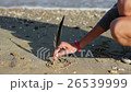 the Girl Draws a Heart by Feather in the Sand on 26539999