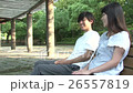 A couple talking with a bench 26557819