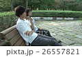 A couple talking with a bench 26557821
