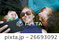 Two teens kiss their friend while taking a selfie 26693092