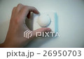 Man adjusting an indoor wall thermostat. 26950703