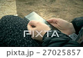 Woman scrolling mobile phone 27025857