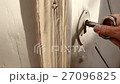 Old male hand Insert key into a ancient Door Lock 27096825