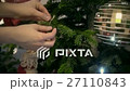 Child decorating a chrtistmas tree 27110843