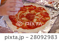 Unrecognized child cooking pizza - putting slices 28092983