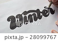 Designer drawing letters with marker 28099767