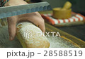 Cut slice of bread in slow motion, close up 28588519