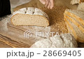 Cut slice of bread on the wooden table, in slow 28669405