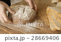 Cut slice of bread on the wooden table, in slow 28669406