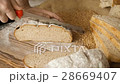 Cut slice of bread on the wooden table, in slow 28669407