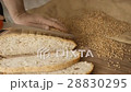 Cut slice of bread on the wooden table, in slow 28830295