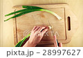 Starting chopping bunch onion on wooden board 28997627