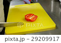 Human hands with knife slicing red bulgarian 29209917