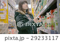 Woman chooses juice in the supermarket 29233117