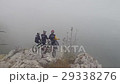Aerial of mountain bikers on mountain in the fog 29338276