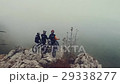 Aerial of mountain bikers on mountain in the fog 29338277