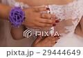 Bridesmaids hands buttoning up beautiful bride 29444649