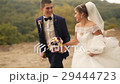 Groom and bride running in the park on summer day 29444723