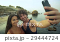 Beautiful young couple taking selfies on the beach 29444724