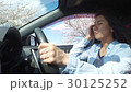 Young lady driving cherry blossom trees 30125252