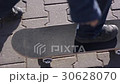 boy learns to ride a skateboard 30628070