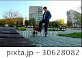 boy learns to ride a skateboard 30628082