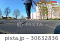 boy learns to ride a skateboard 30632836