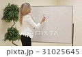 Smiling motivated female business trainer writing 31025645