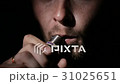 Young man smoking electronic cigarette on black 31025651