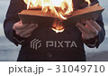 Young man with burning book in hand standing on 31049710