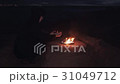 Young man In black jacket seating near bonfire of 31049712