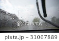 Windshield wiper clearing rain drops during storm. 31067889