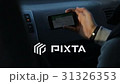 Man with fitness bracelet on hand looking on the 31326353