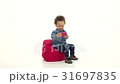 Child is an african american, sits on a pillow and 31697835