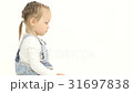 Little girl is sitting on her lap and looking at 31697838