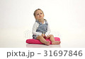 Little girl lies on the floor and raises her legs 31697846