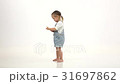 Little girl holds a phone in his hands and talks 31697862